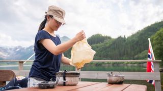 how to clean your hiking stove: hiker sorting her stove