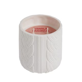 A white cable knit pattern candle