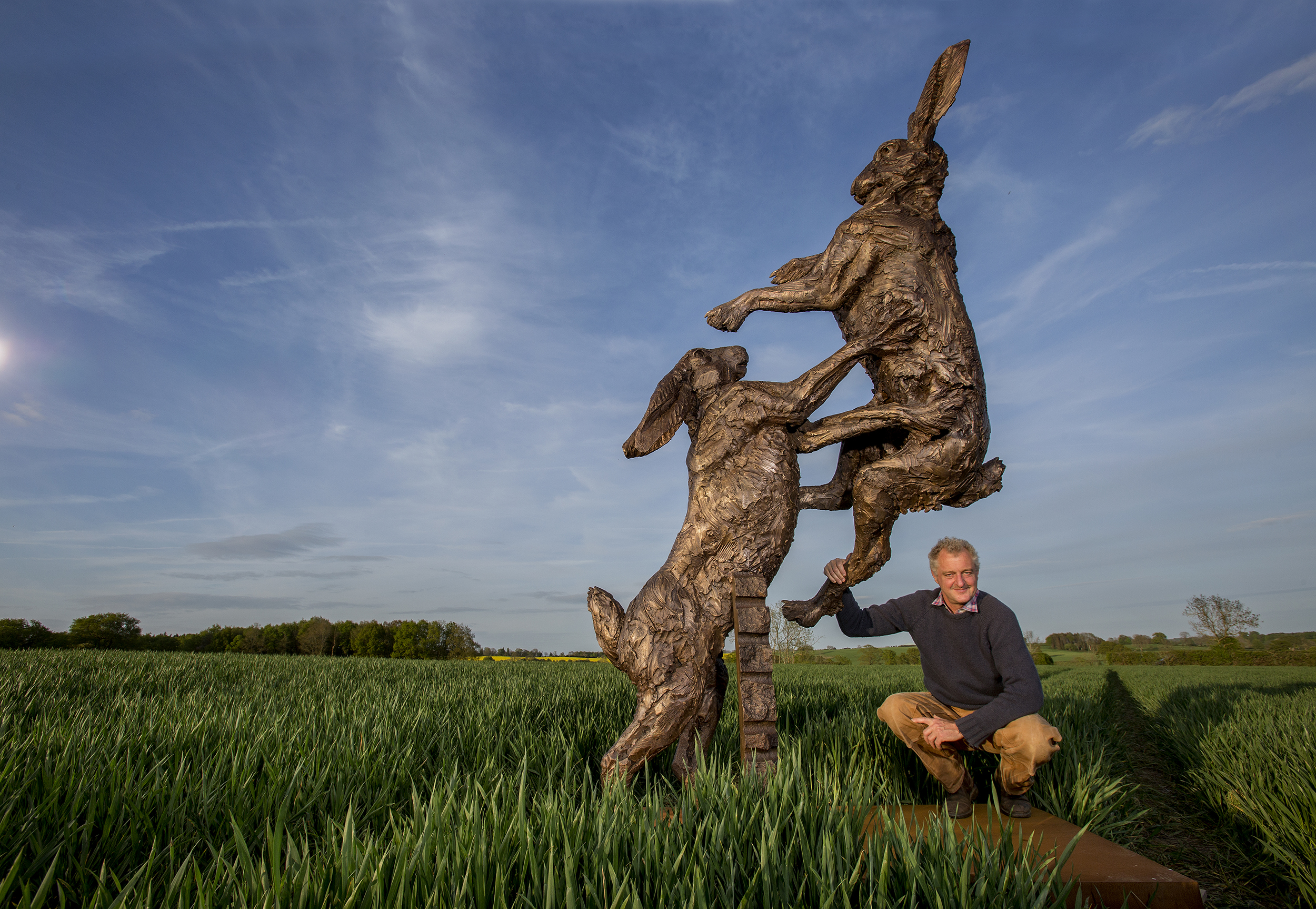 Sculptor Hamish Mackie with his bronze Hares Monumental.
