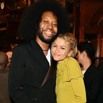 Zendaya joins playwright Jeremy O. Harris at the Slave Play photocall wearing a vintage Dior sweater, a skirt, and summer's high boot trend