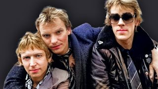 The Police..Sting (lead singer,guitar), Stewart Copeland(drums), Andy Summers(guitar)..The group poses exclusive outside of the tv studios in Amsterdam, The Netherlands, circa 1982