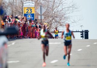 Elite women runners pass the Brookline 23 mile marker in the 2016 Boston Marathon