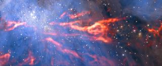 Wispy filaments of gas reveal the details of star formation in one branch of the Orion Nebula. The features appear red-hot and fiery in the image but are actually extremely cold.