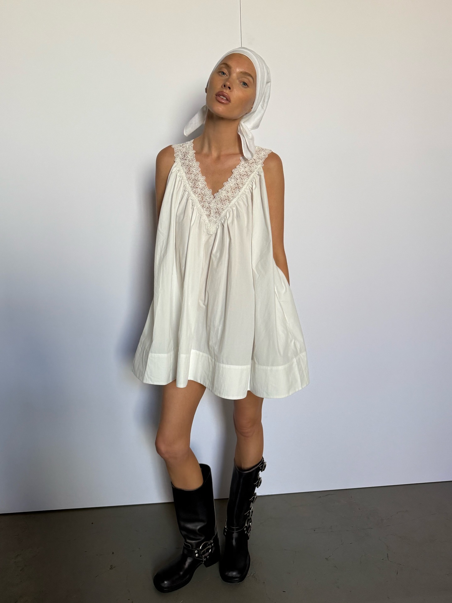 Elsa Hosk wore a white sleeveless mini skirt with black biker boots and a white turban.