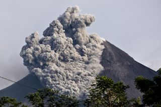 An image from October 2010 shows an earlier blast of dust out of the volcano.