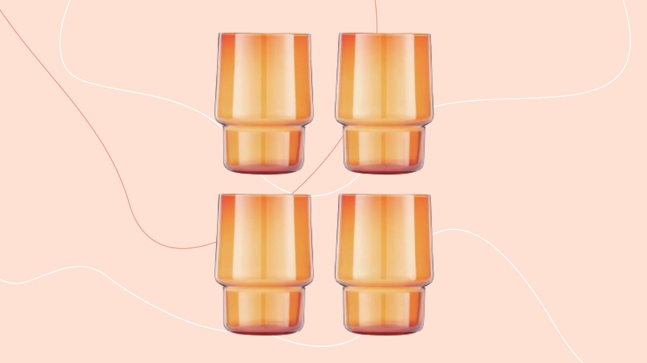 Stackable tumbler glasses against pink background