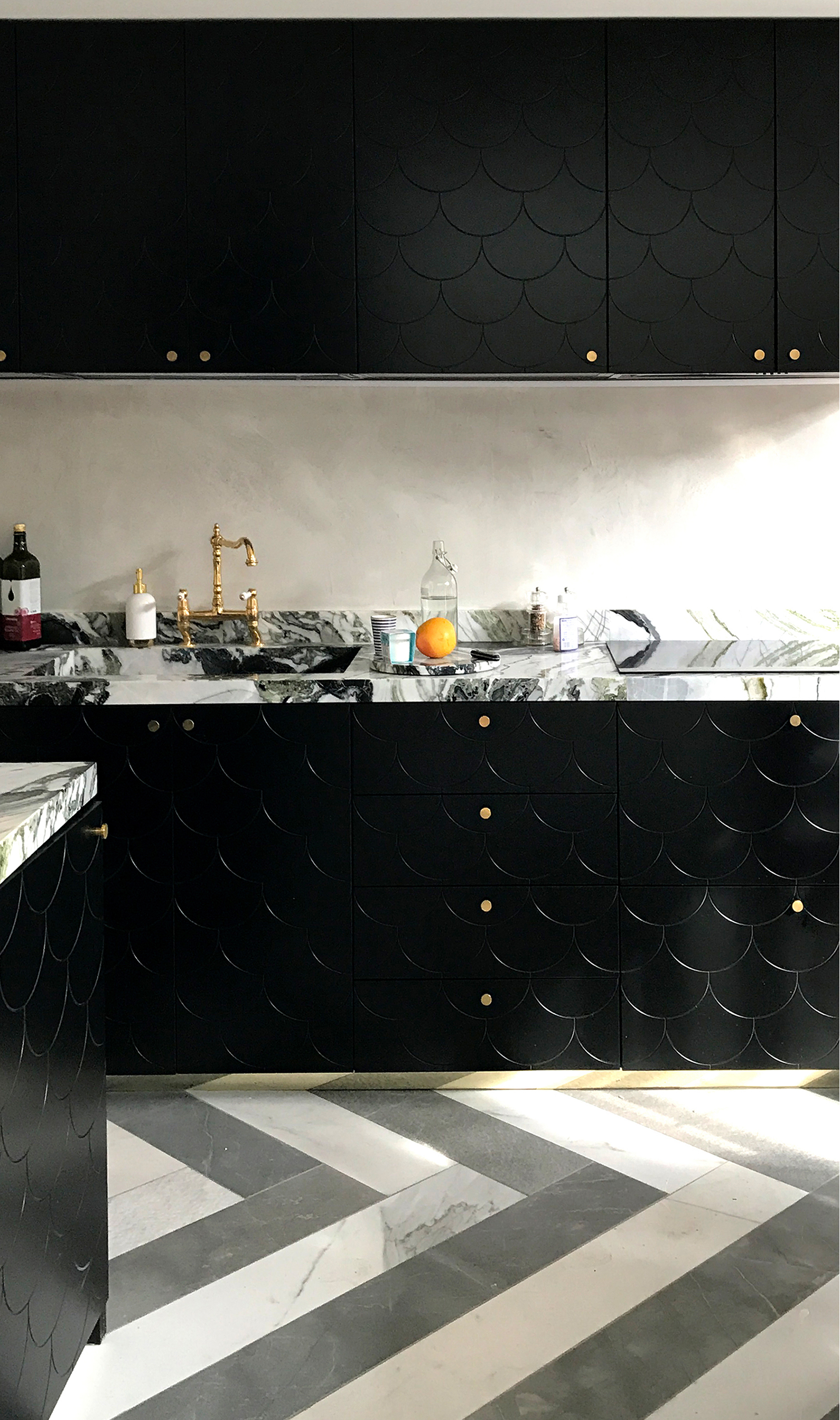 black kitchen cupboards with marble worktops