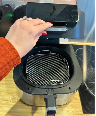 Metal rack in my air fryer, the lid is open to show it nestled in my basket