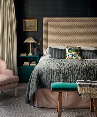 bedroom with dark walls and patterned headboard