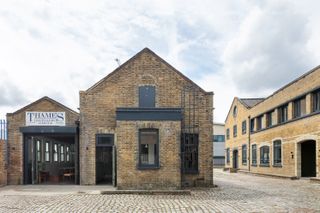 Thames Distillers new home and Fords bar, is an industrial gin brick distillery with a glamorous bar clad in green stone