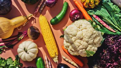 A selection of fibre-rich foods to beat the autumn slump, including cauliflower, onions and starchy vegetables
