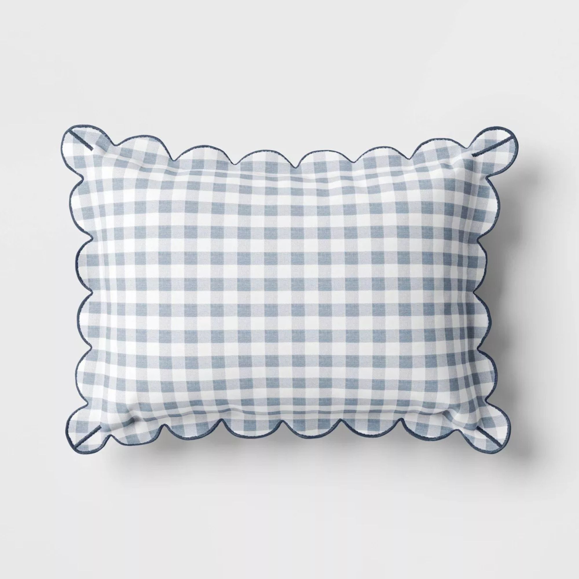 Blue and white gingham outdoor pillow with scalloped edges