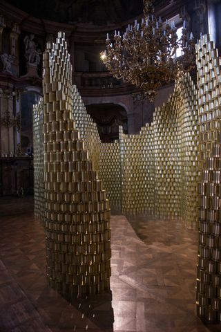 A maze like structure made from 5000 empty gold cans