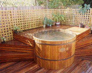 hot tub with decking and screens