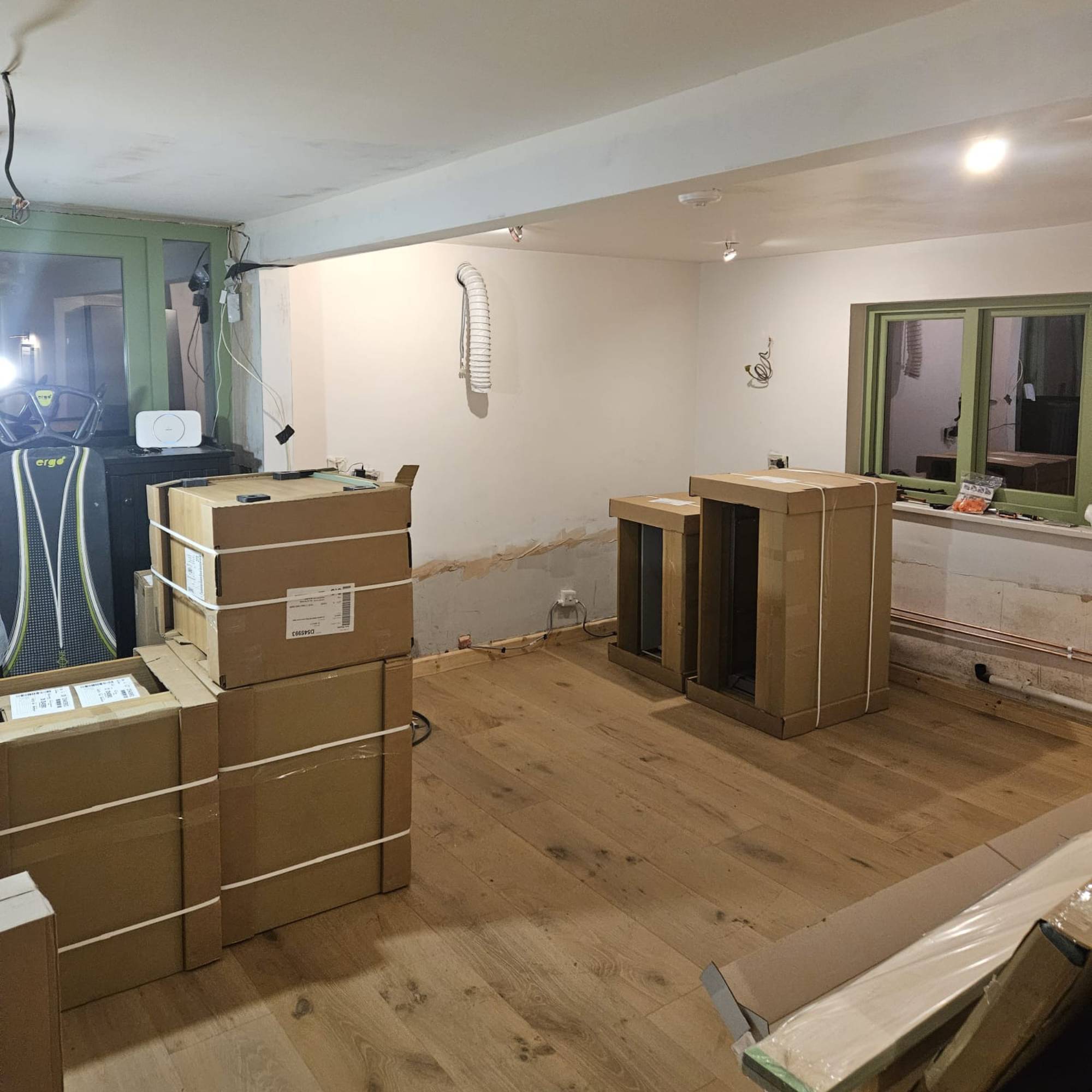 wood floor in renovated kitchen with units in boxes