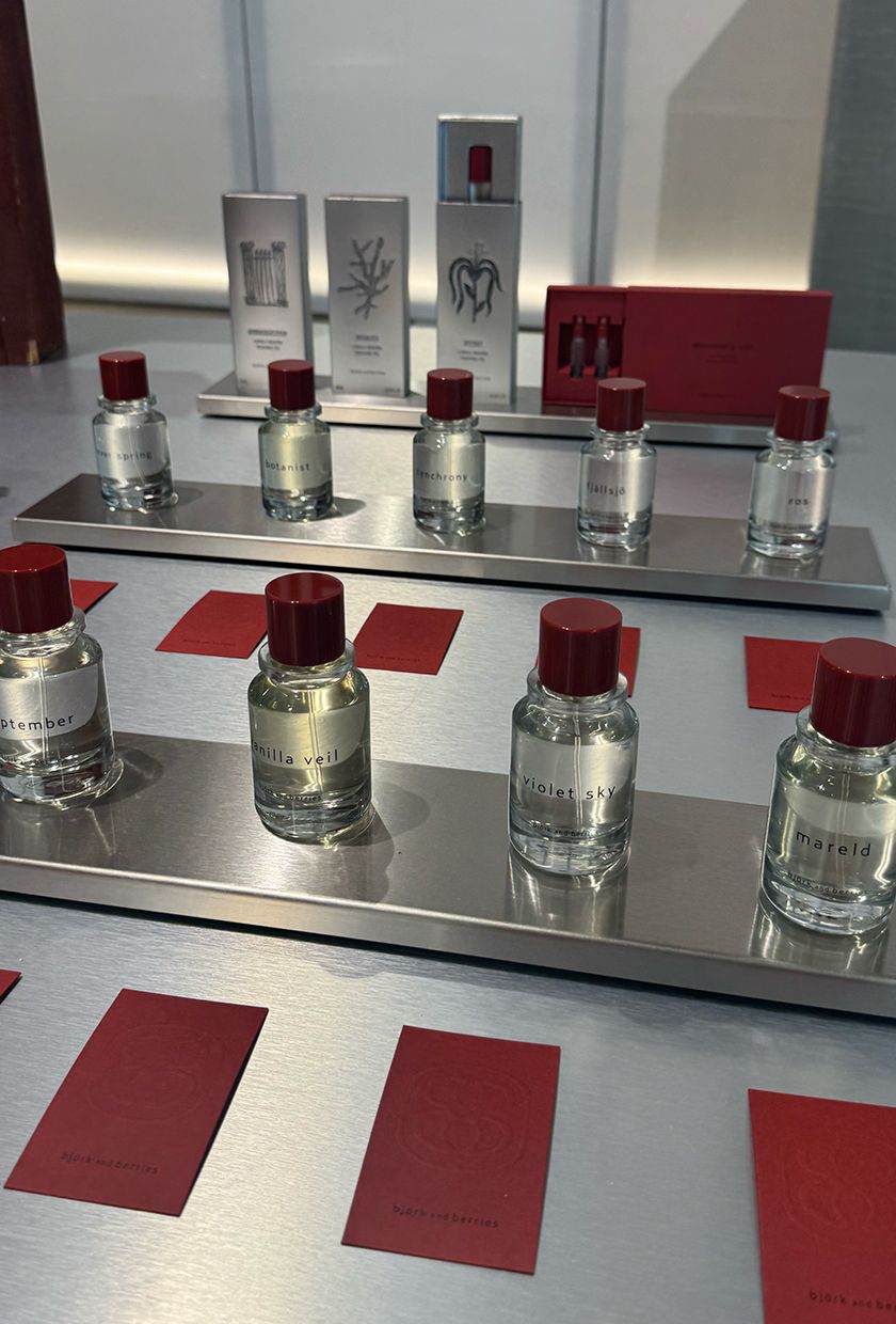 bjork and berries perfume bottles with red caps on a silver table