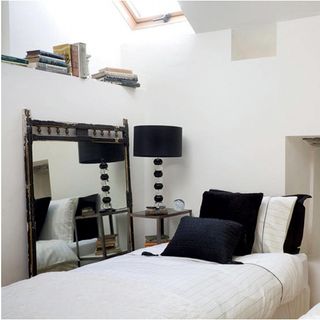 white bedroom with bed and black lamp lights