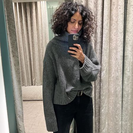 Neelam wears a grey sweater from The Row