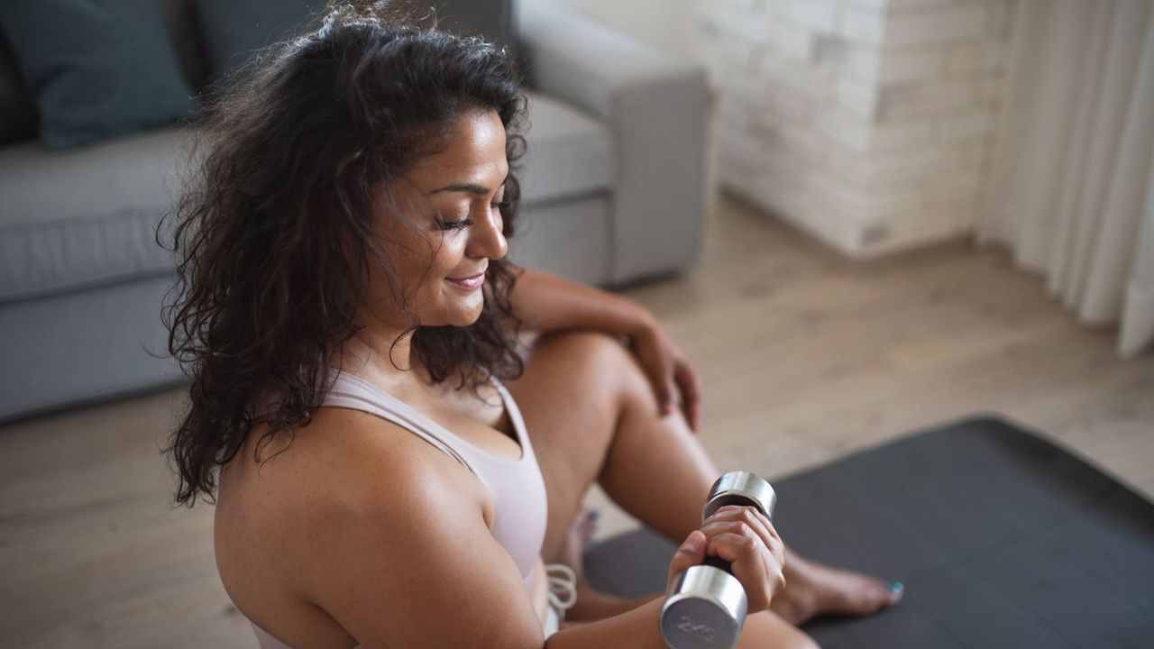 Woman does dumbbell workout