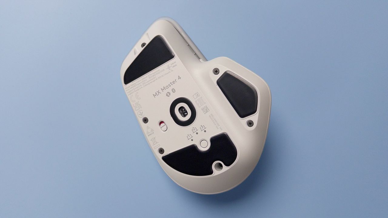 The Logitech MX Master 4 mouse against a blue background.