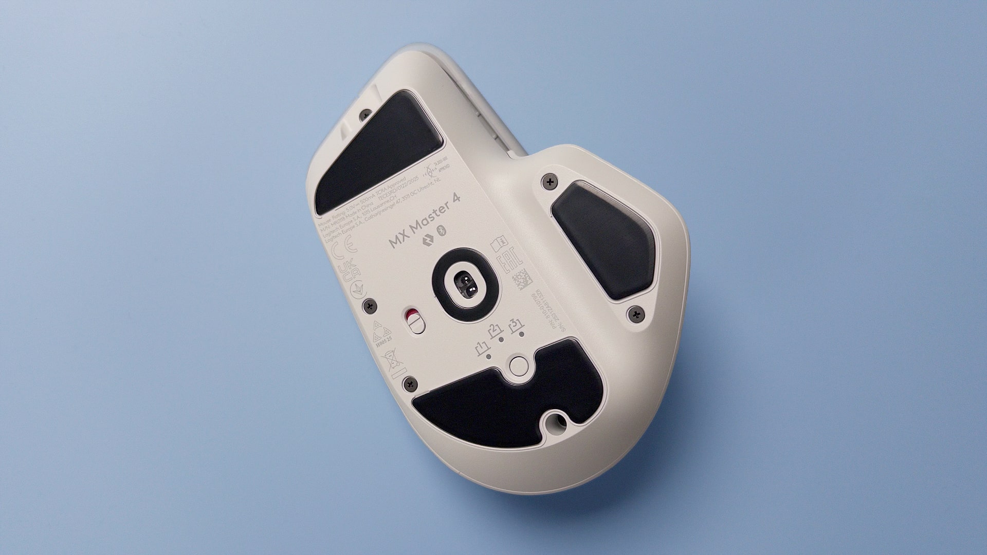 The Logitech MX Master 4 mouse against a blue background.