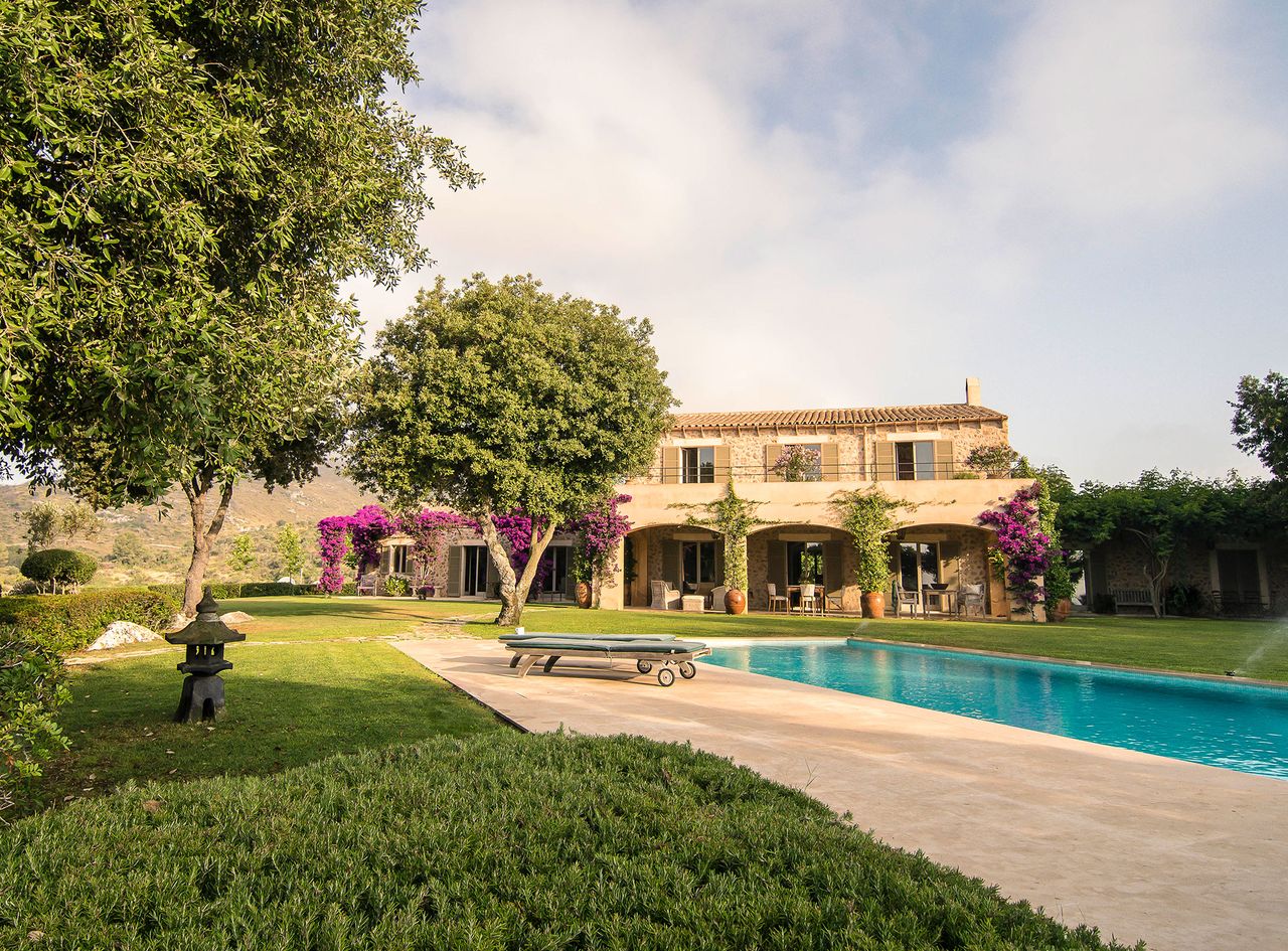 Exterior of stone built Mallorcan home with pool