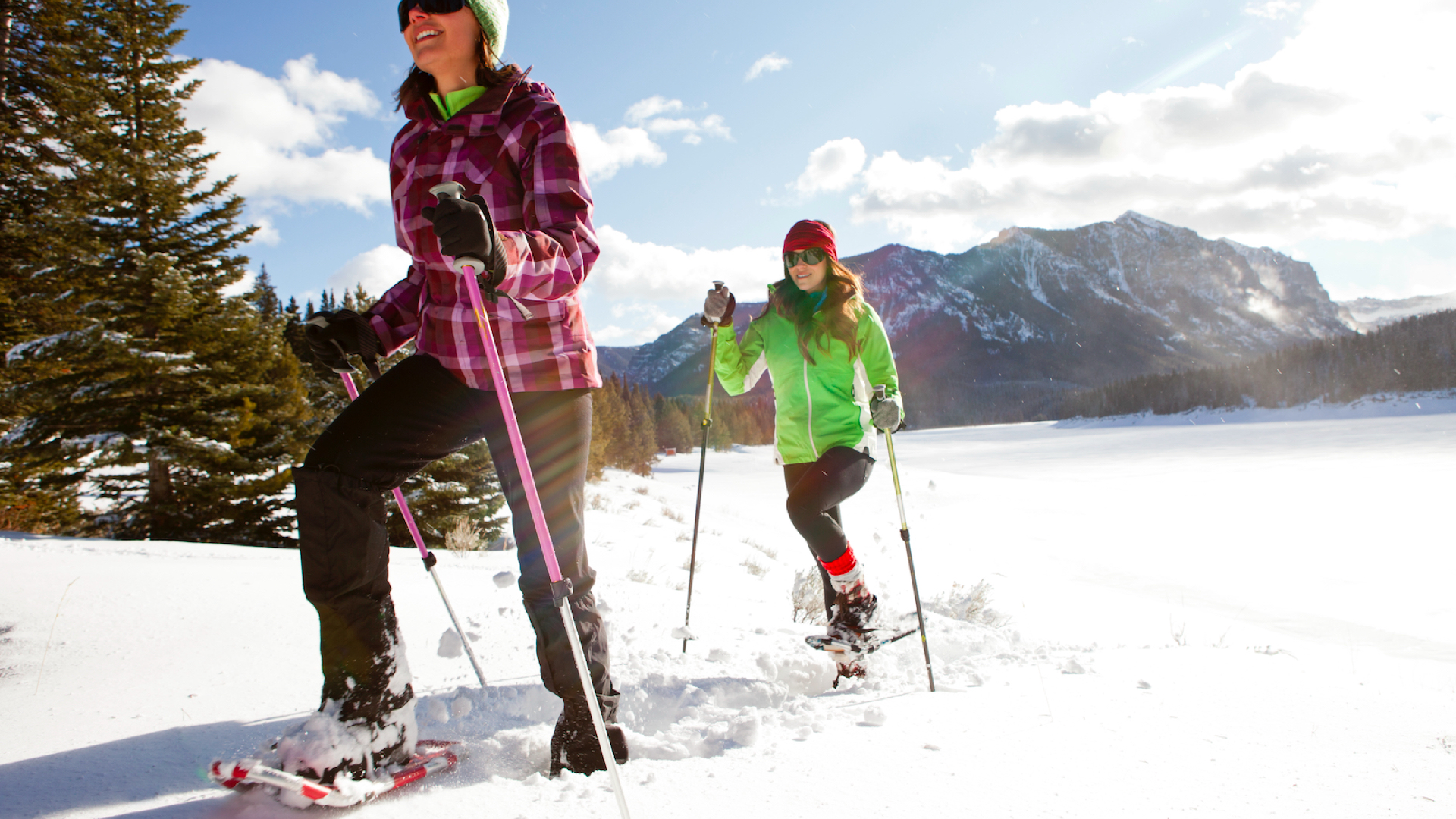 Best Snowshoes – Two women snowshoeing in Hyalite Canyon on a sunny winter day.