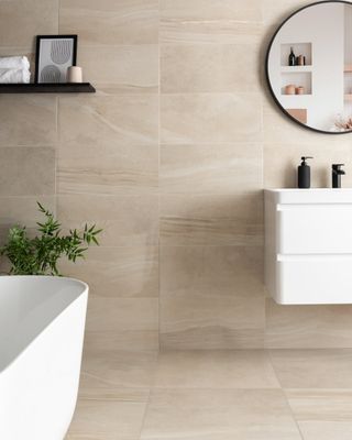 A bathroom with ivory Stone Effect Polished Porcelain Wall and Floor Tiles and a white bathtub and sink