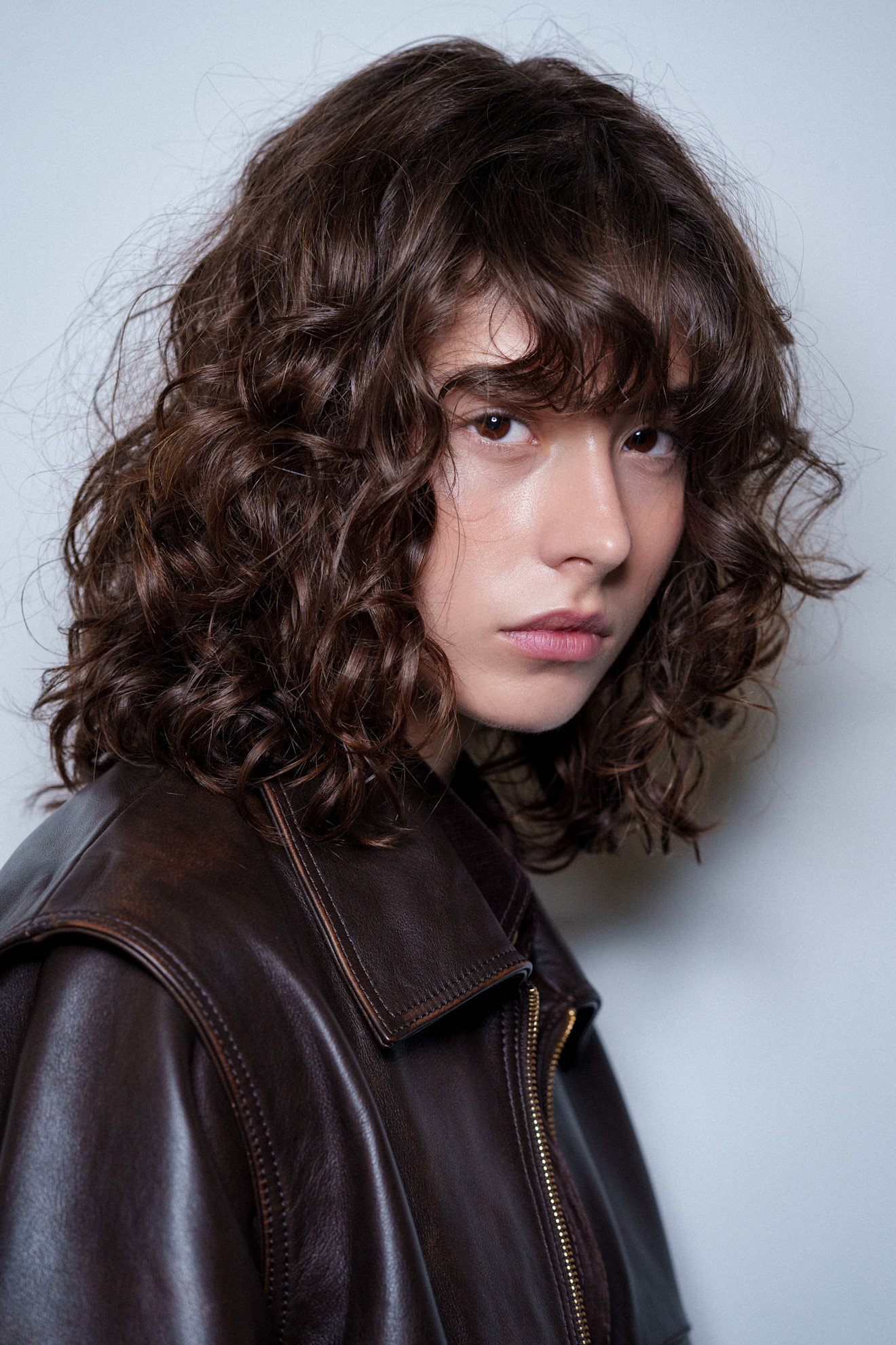 Person with shaggy curly bangs.