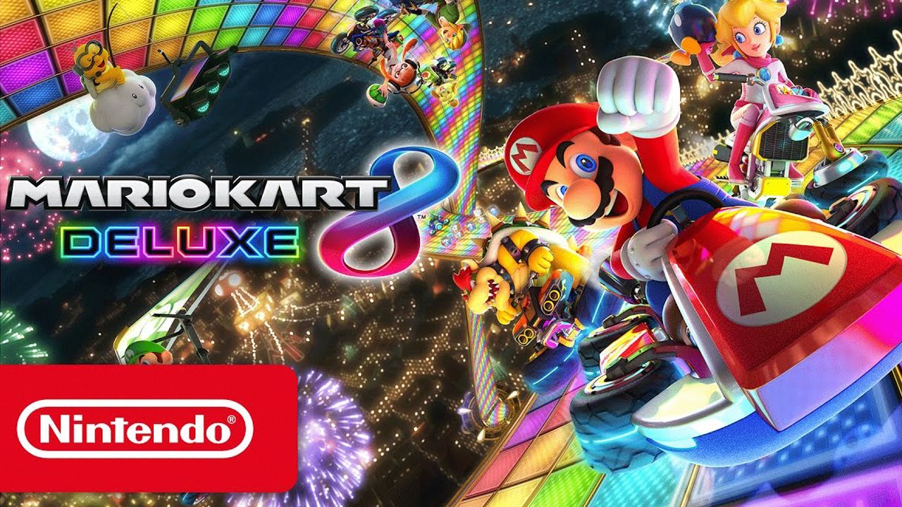 Key art from Mario Kart 8 Deluxe showing Mario in a kart, throwing his fist into the air.