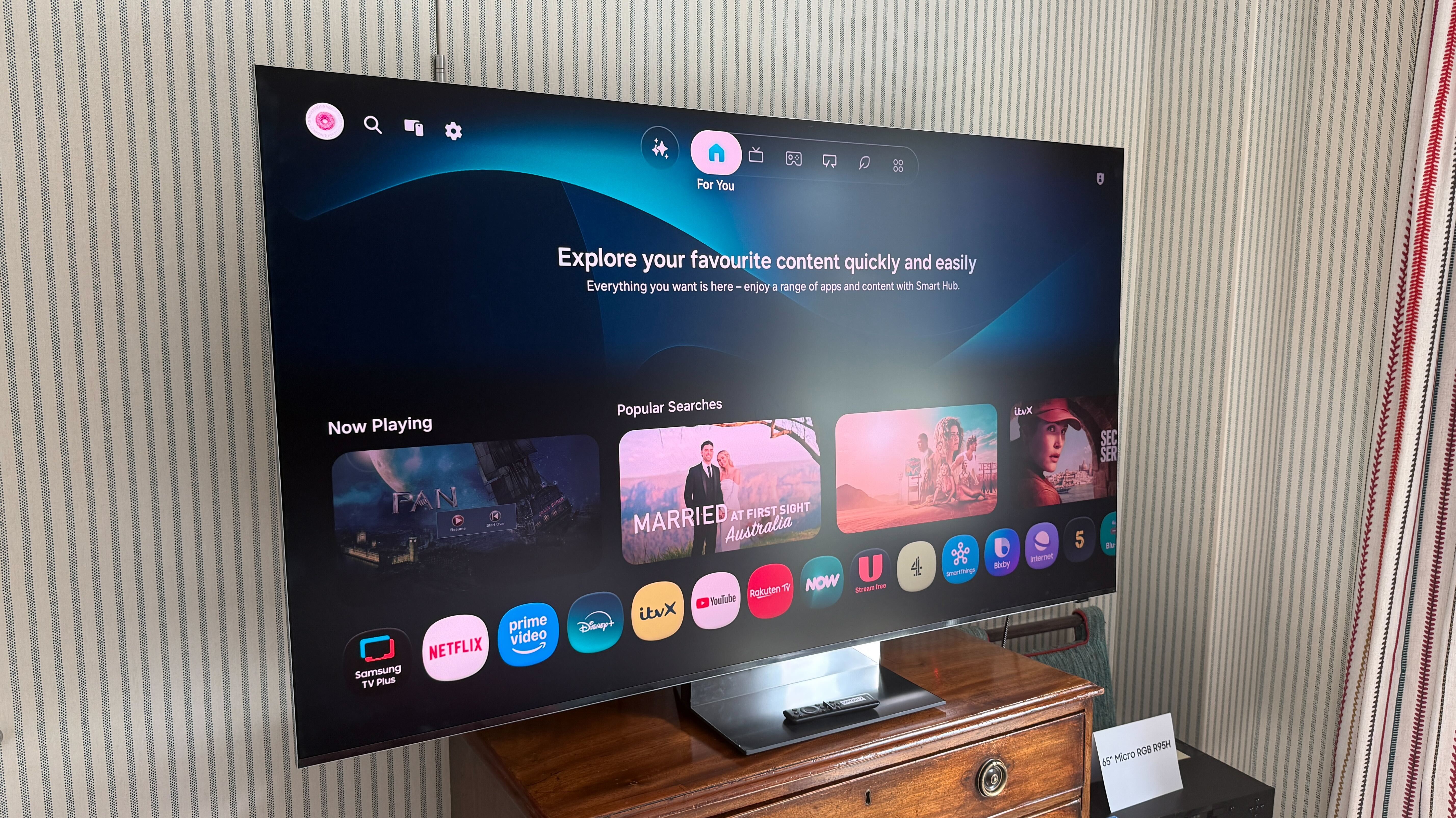 Samsung R95H on top of a wooden chest of drawers