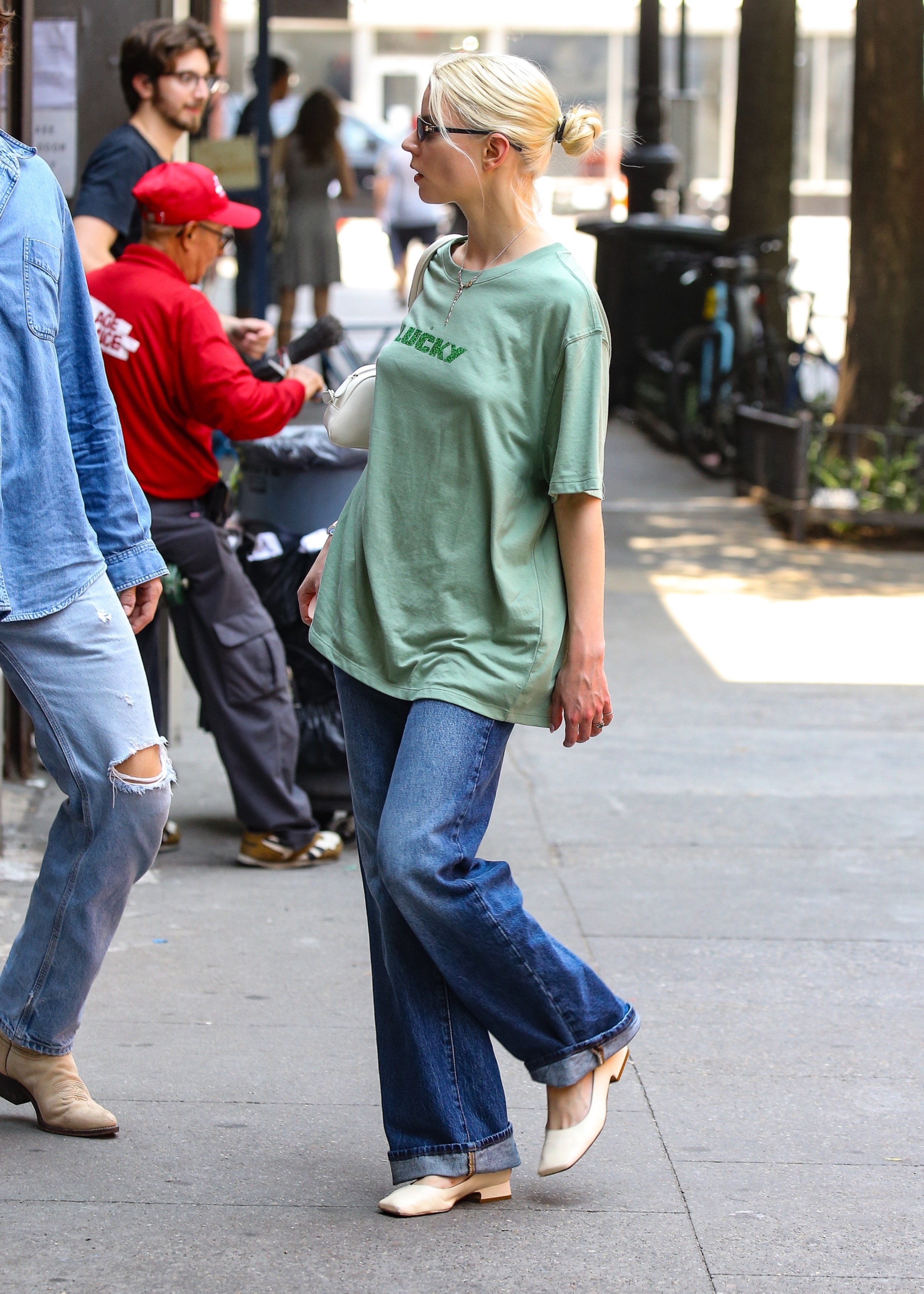 Anya Taylor-Joy was spotted enjoying a low-key day in New York City, keeping it casual in an oversized green graphic tee, relaxed jeans, Tiffany &amp;amp; Co. jewelry, and sunglasses.