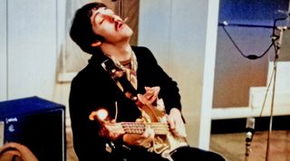 Bassist Paul McCartney of the rock and roll band the Beatles records bass in the studio in circa 1967.