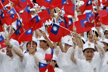 Taiwanese people wave their national flag during celebrations in capital Taipei to commemorate the foundation of the Republic of China