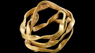 This gold artifact, which may have been used as a hair ornament, was found buried with a woman who died around 3,800 years ago. 