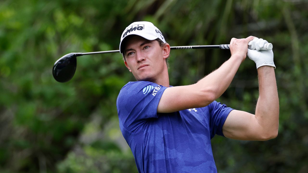 A close-up shot of Maverick McNealy swinging his driver while wearing a royal blue polo shirt