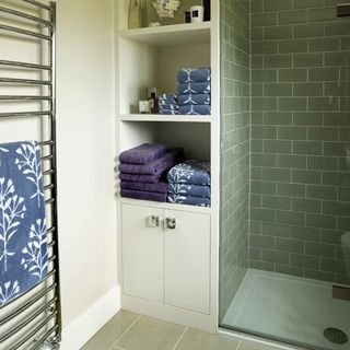 bathroom with shelving and towels