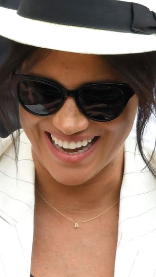 meghan markle wearing one of her initials necklaces