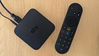 Sky Stream review: puck and remote on a wooden side table