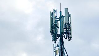 A mobile network mast with overcast sky