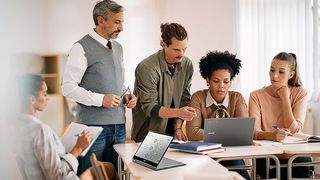 A team gathers around an Acer Chromebook Spin in an office