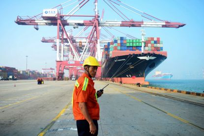 A worker near a Chinese cargo ship