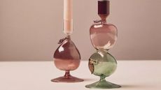 Anthropologie fall 2025 harvest fruit candle holders against a warm, redish background