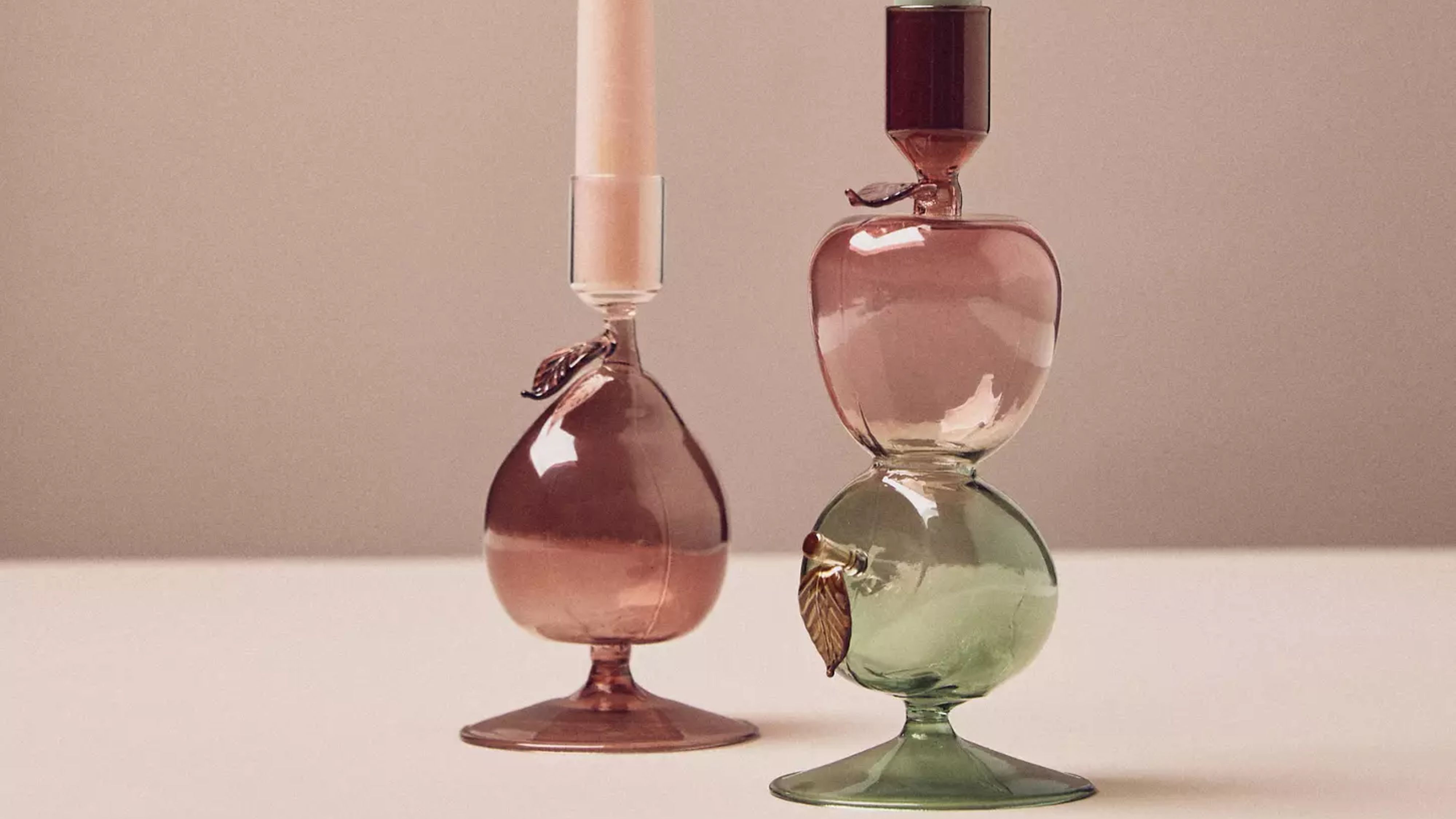 Anthropologie fall 2025 harvest fruit candle holders against a warm, redish background
