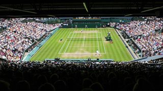 A capacity crowd watches Roger Federer of Switzerland during the Men's Final match on Centre Court at the Wimbledon Tennis Championships.
