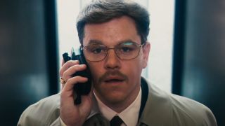 Matt Damon in The Informant! looking shocked holding a phone to his ear.
