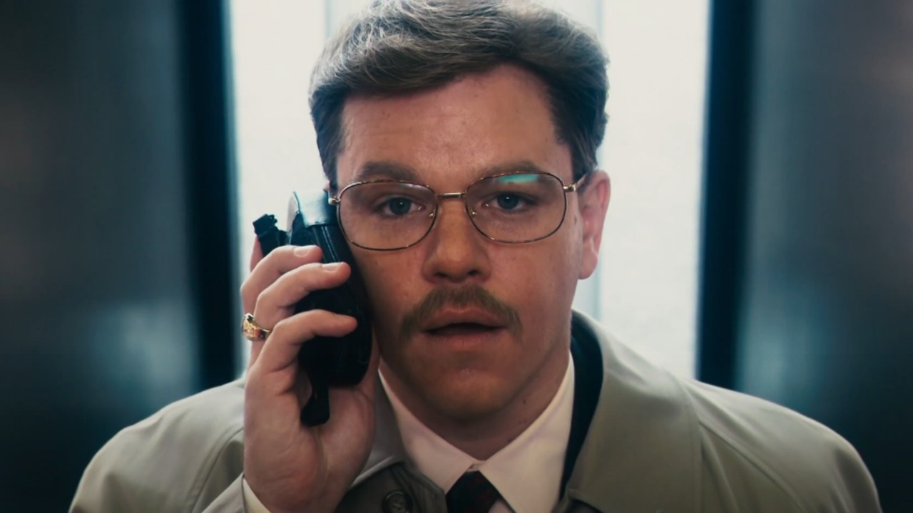 ¡Matt Damon en El informante!  luciendo sorprendido sosteniendo un teléfono en su oído.