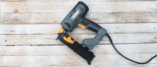 Titan TTB970NST 32mm Second Fix Electric Nail Gun / Stapler on whitewashed wood background