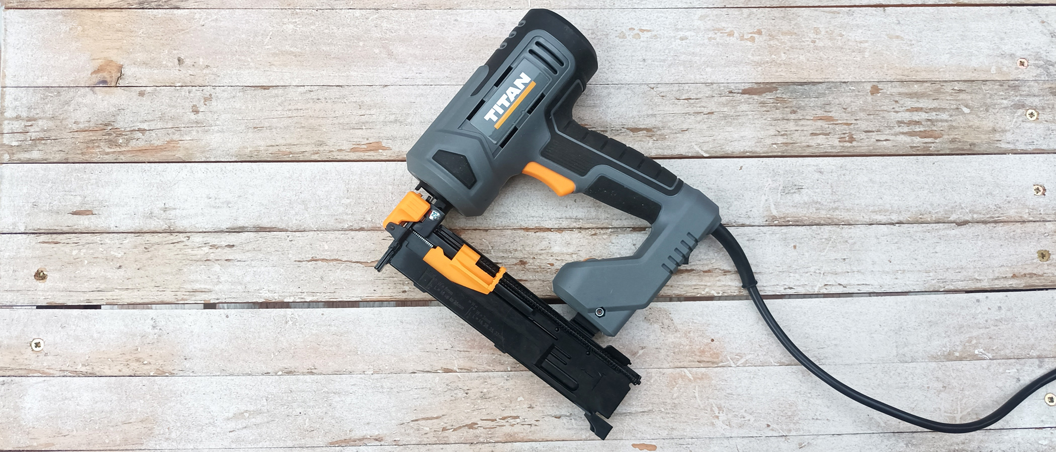 Titan TTB970NST 32mm Second Fix Electric Nail Gun/Stapler on whitewashed wood background