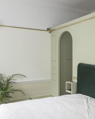 bedroom with white bedlinen and potted plant